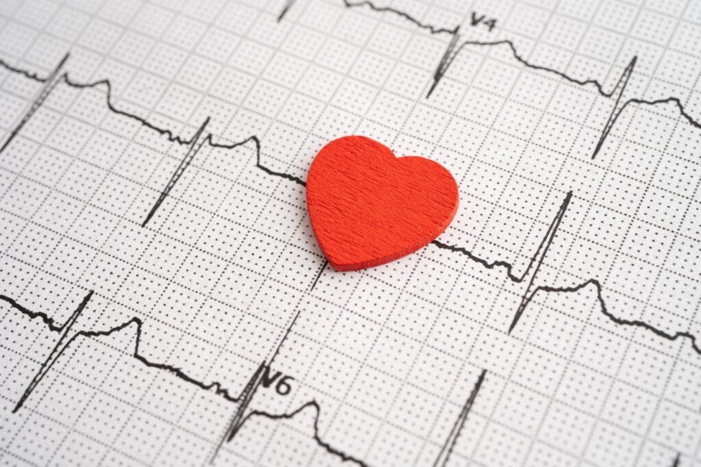 Red heart on electrocardiogram ECG with red heart, heart wave, heart attack, cardiogram report.